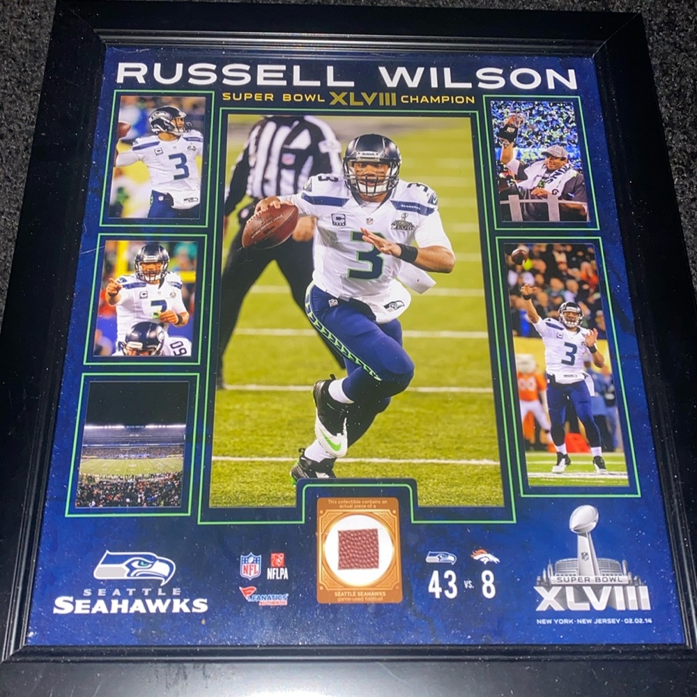 Authentic NFL branded Russell Wilson game used football piece plaque. 17”X 15”in
